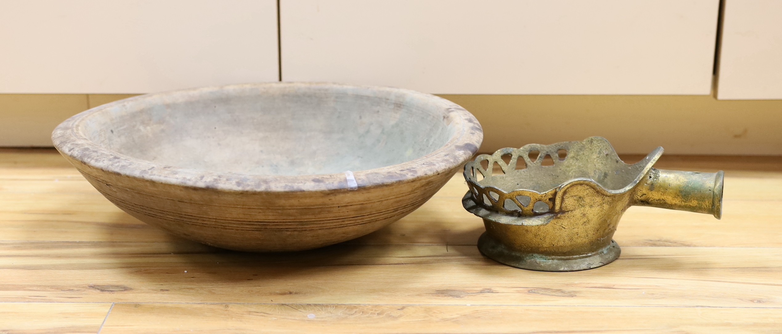 A 19th century Sycamore maizer bowl and a Chinese cast metal silk iron, diameter of bowl 42cm